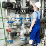 A plumber inspects the water supply and pumps systems to ensure adequate pressure.